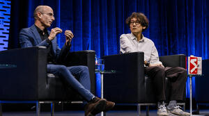 Yuval Noah Harari and Kohei Saito sit on a stage and speak to the audience