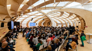 Photo of the inside of the Frankfurt Pavilion Stage with people in the audience.