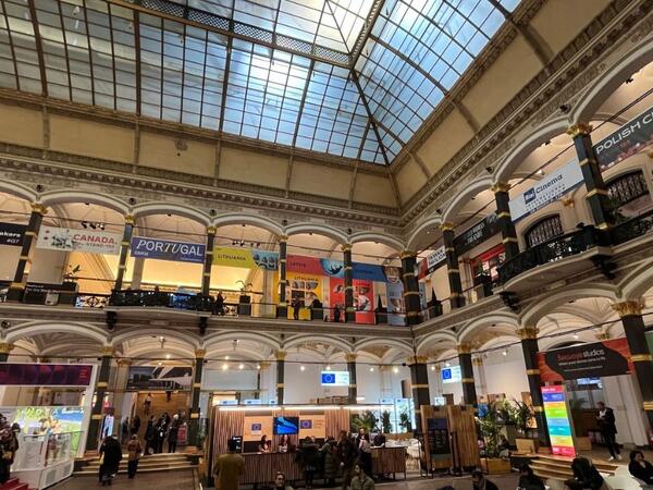 Entrance hall with domed building where people are around